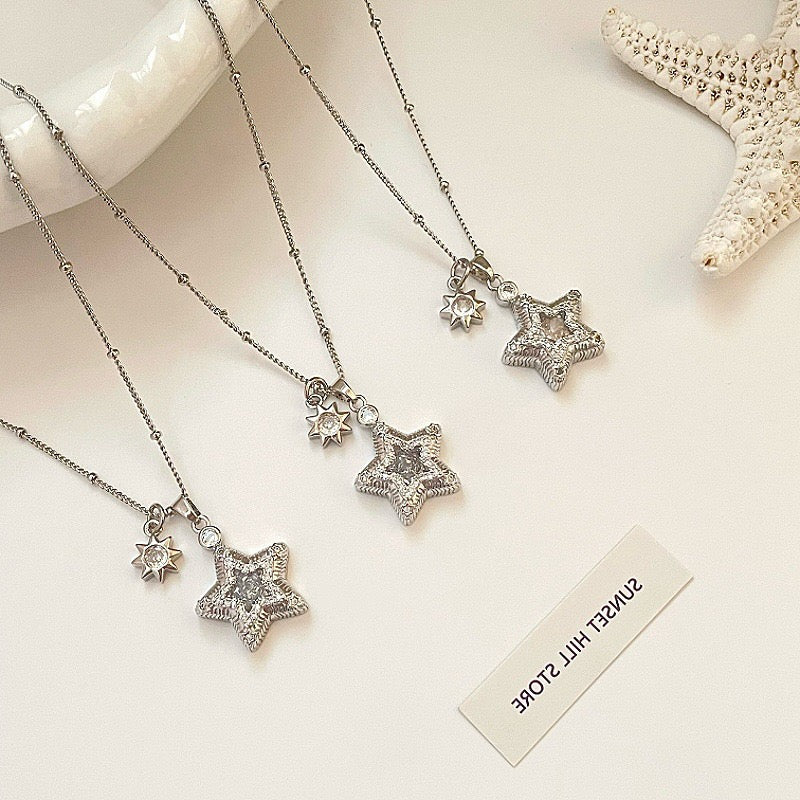 Star-themed earrings with zircon accents and a matching necklace set.