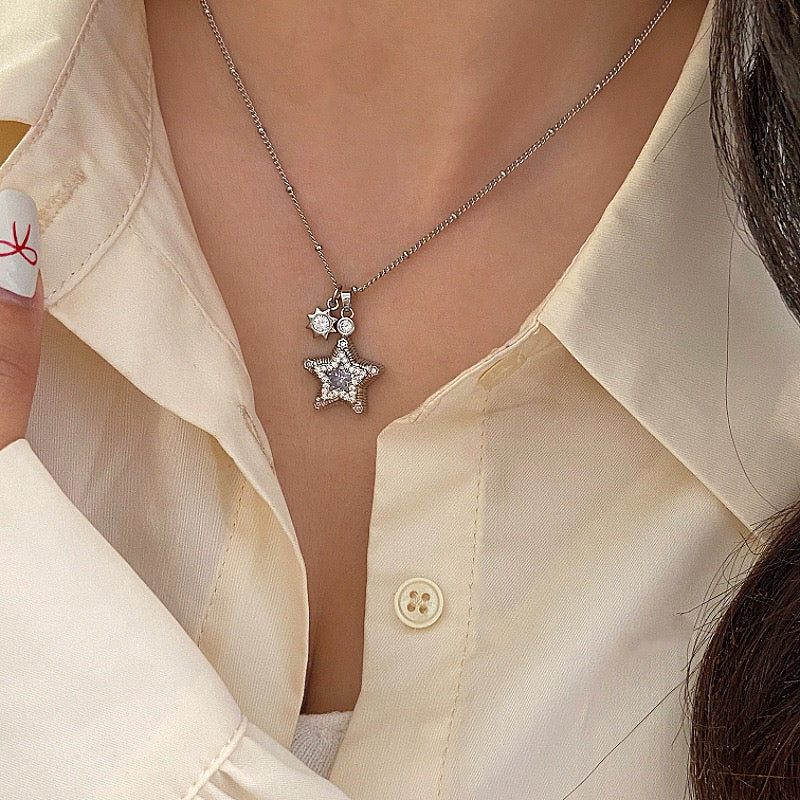 Star-themed earrings with zircon accents and a matching necklace set.